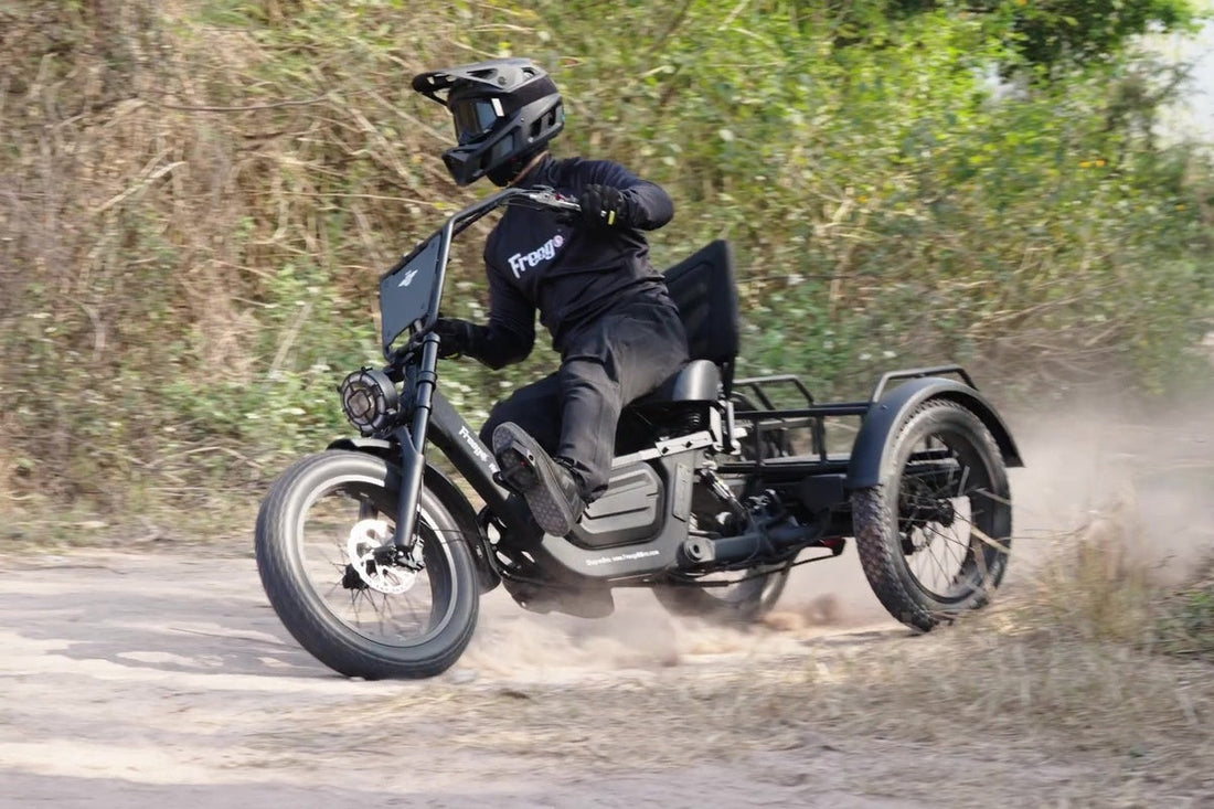 Rider riding an electric trike for commuting and errands on a dirt kicking up dust.