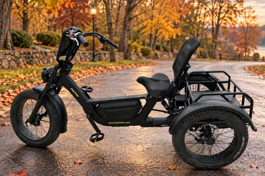 The FlekTrike Pro illustrates electric trike fall riding tips on a quiet road with damp pavement and autumn leaves.