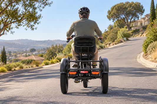 A rider climbs a quiet California neighborhood road on the FlekTrike Pro All-Terrain Tilting eTrike, an electric trike for California hills.