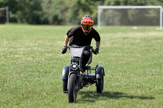 Rider on a three-wheeled electric vehicle, demonstrating the electric trike vs e-bike difference.