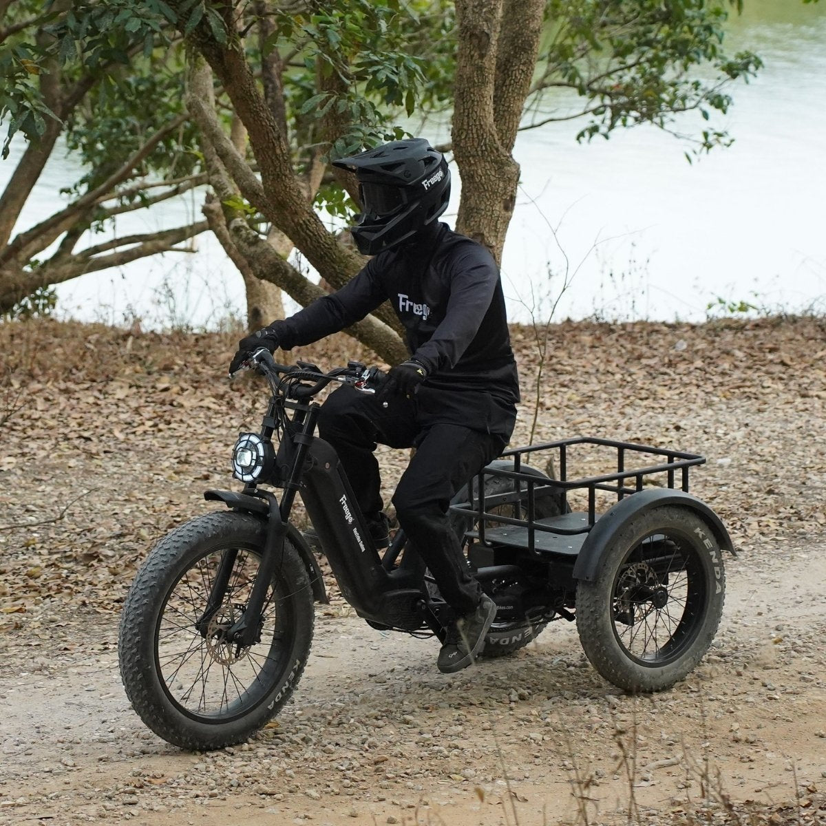 Person riding a freego flextrike swing on a dirt path with trees and water in the background