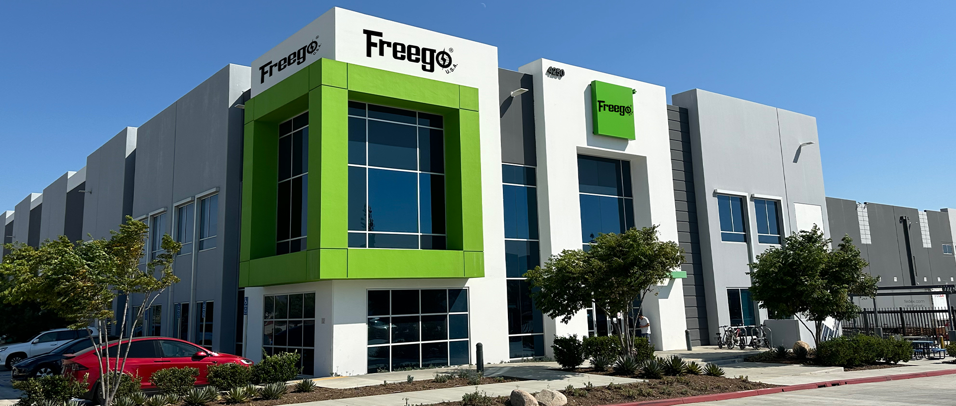 Freego building with green accents on a clear day