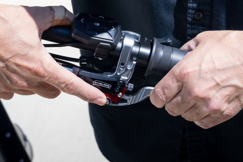 Hand engaging the parking brake on
the FlekTrike Pro All-Terrain Tilting.